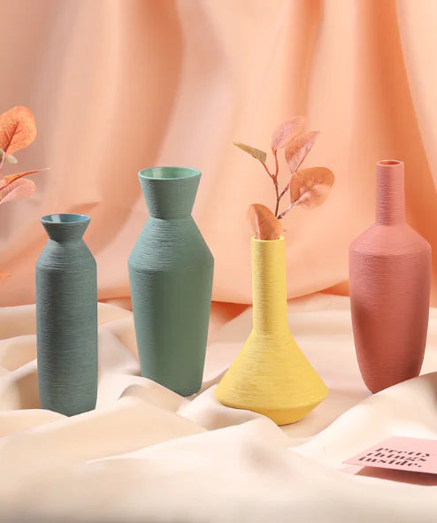 Set of colorful vases on a soft fabric background