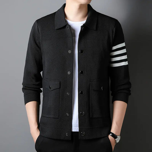 Black jacket with white stripes on sleeve against a gray background