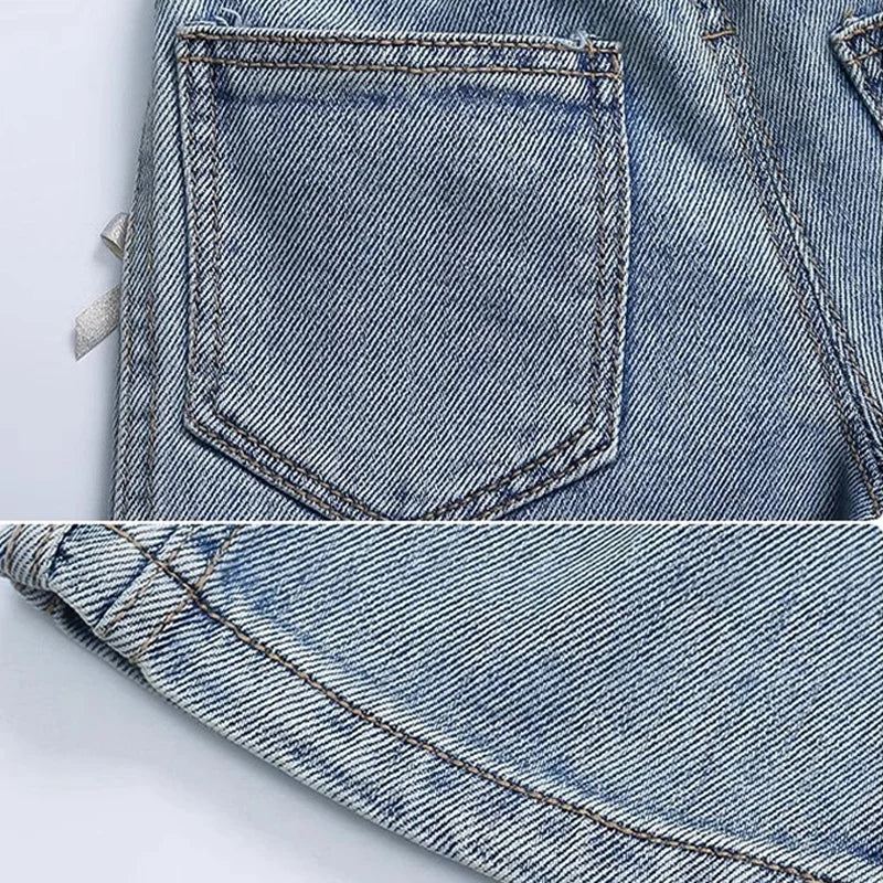 Close-up of blue denim fabric with a pocket detail on a light gray background