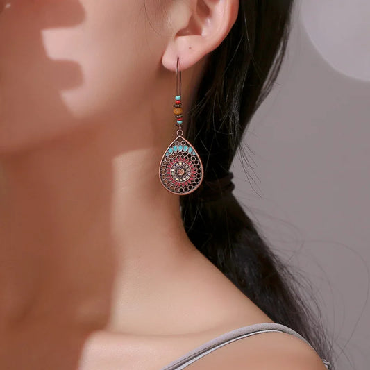Close-up of a person wearing an ornate earring with a blurred background