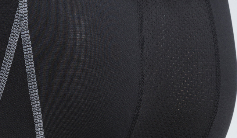 Close-up of a black athletic outfit with a zipper on a white background