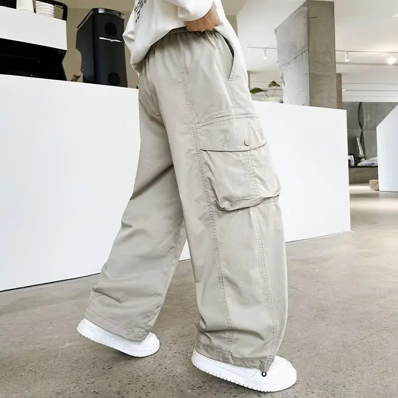 Person wearing beige cargo pants in a modern indoor setting