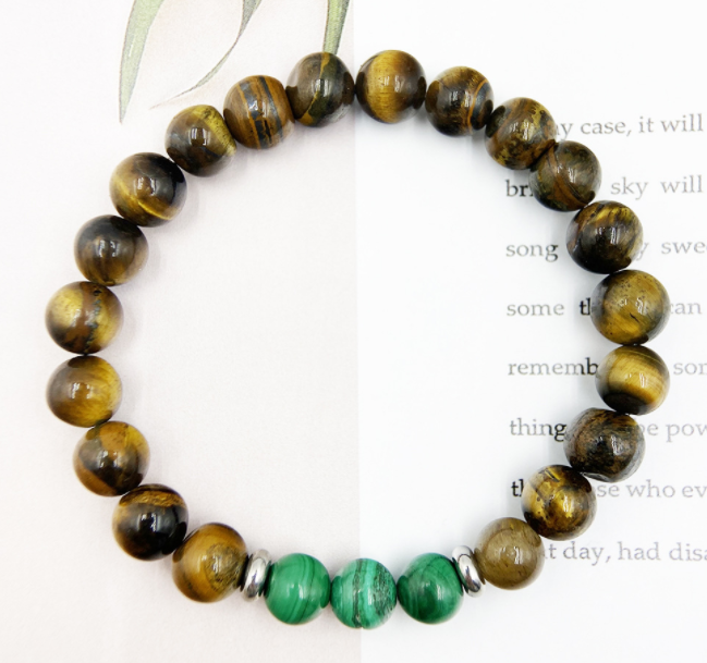 Beaded bracelet with tiger eye and green beads on a white background