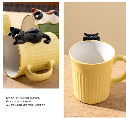 Yellow mug with a black cat-shaped spout on a wooden surface