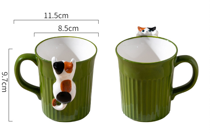 Two green ceramic mugs with cat-shaped handles, showing measurements on a white background.