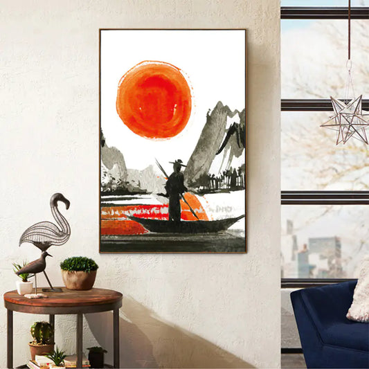 Framed artwork of a person in a boat with a large orange circle, placed on a wall in a room with a window and decorative items.
