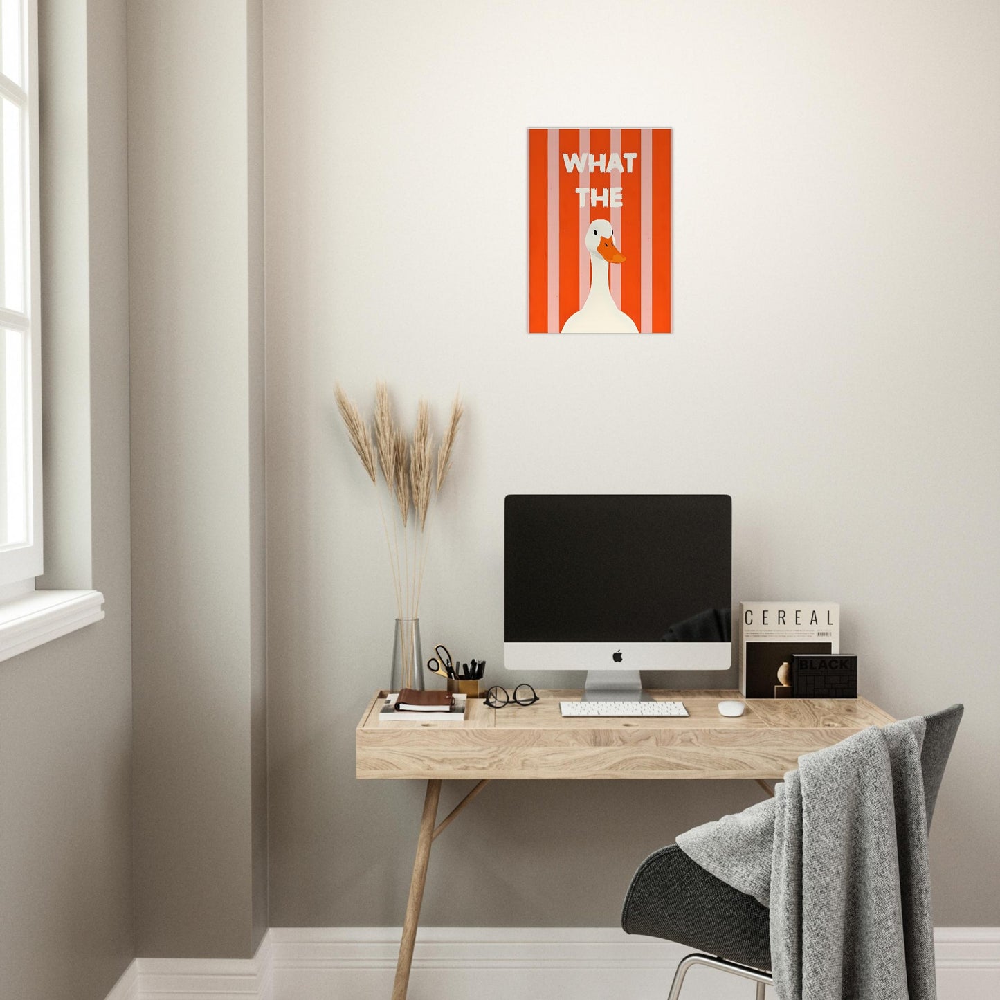 Modern home office with a desk, computer, and wall art.