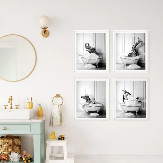 Set of four framed black and white prints of a child in a bathtub on a wall above a bathroom vanity.