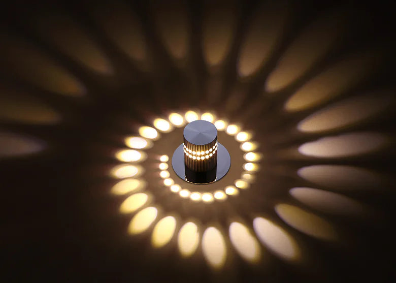 Ceiling light fixture casting circular shadows on a dark ceiling