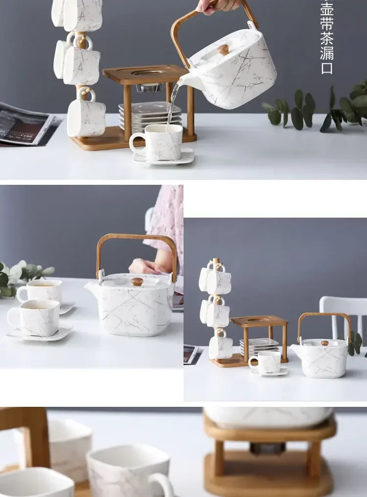 Tea set with marble-patterned teapot and wooden stand on a table.