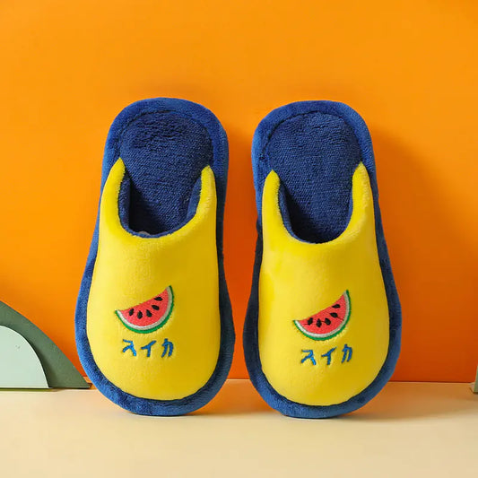 Pair of yellow slippers with blue soles and watermelon design on an orange background