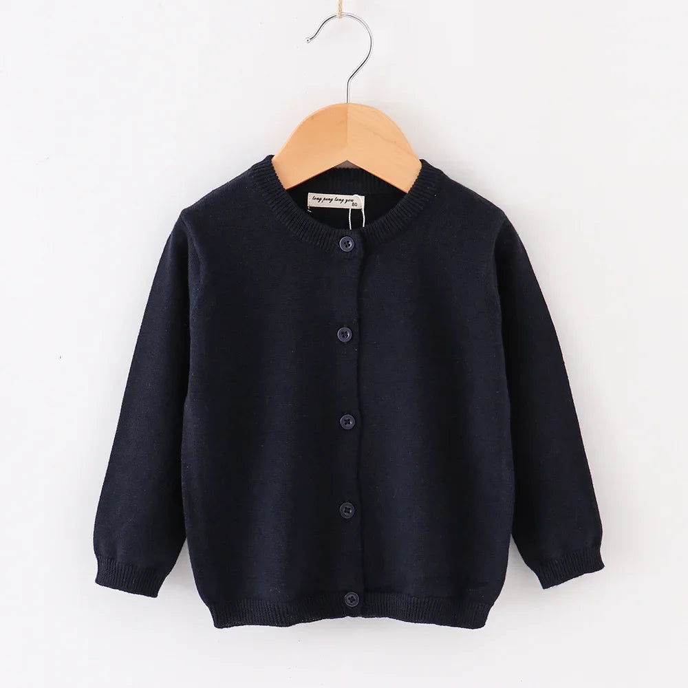 Navy blue cardigan on a wooden hanger against a white background