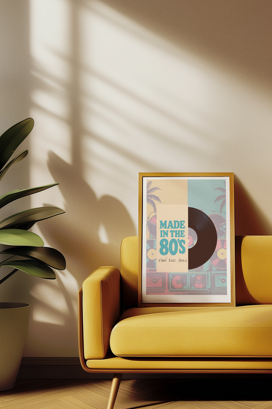 Yellow armchair with a framed poster titled 'Made in the 80s' on a beige wall.