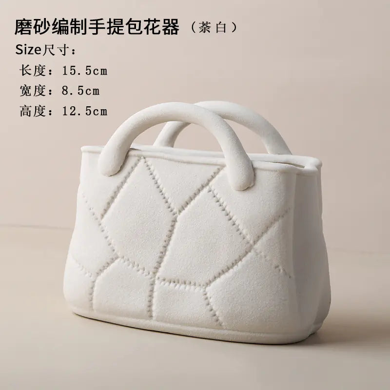 White textured handbag with quilted design on a beige background