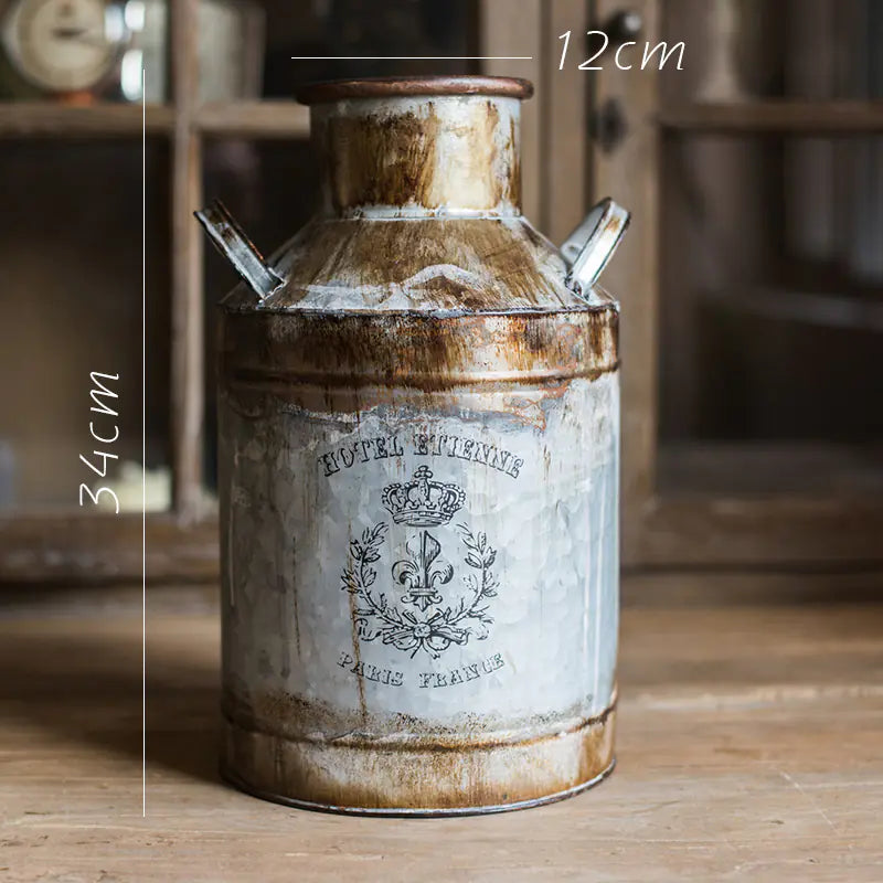 Vintage-style metal canister with decorative label on a wooden surface, showing dimensions.