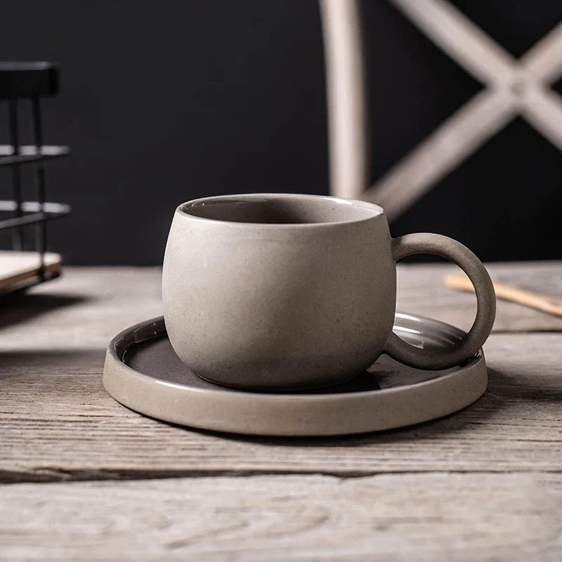 Ceramic cup and saucer set on a wooden surface with a dark background