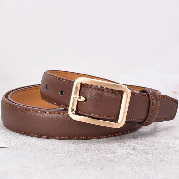 Brown leather belt with a gold buckle on a light gray background