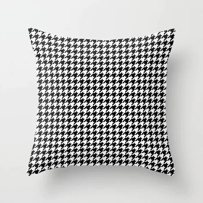 Houndstooth patterned pillow on a light gray background