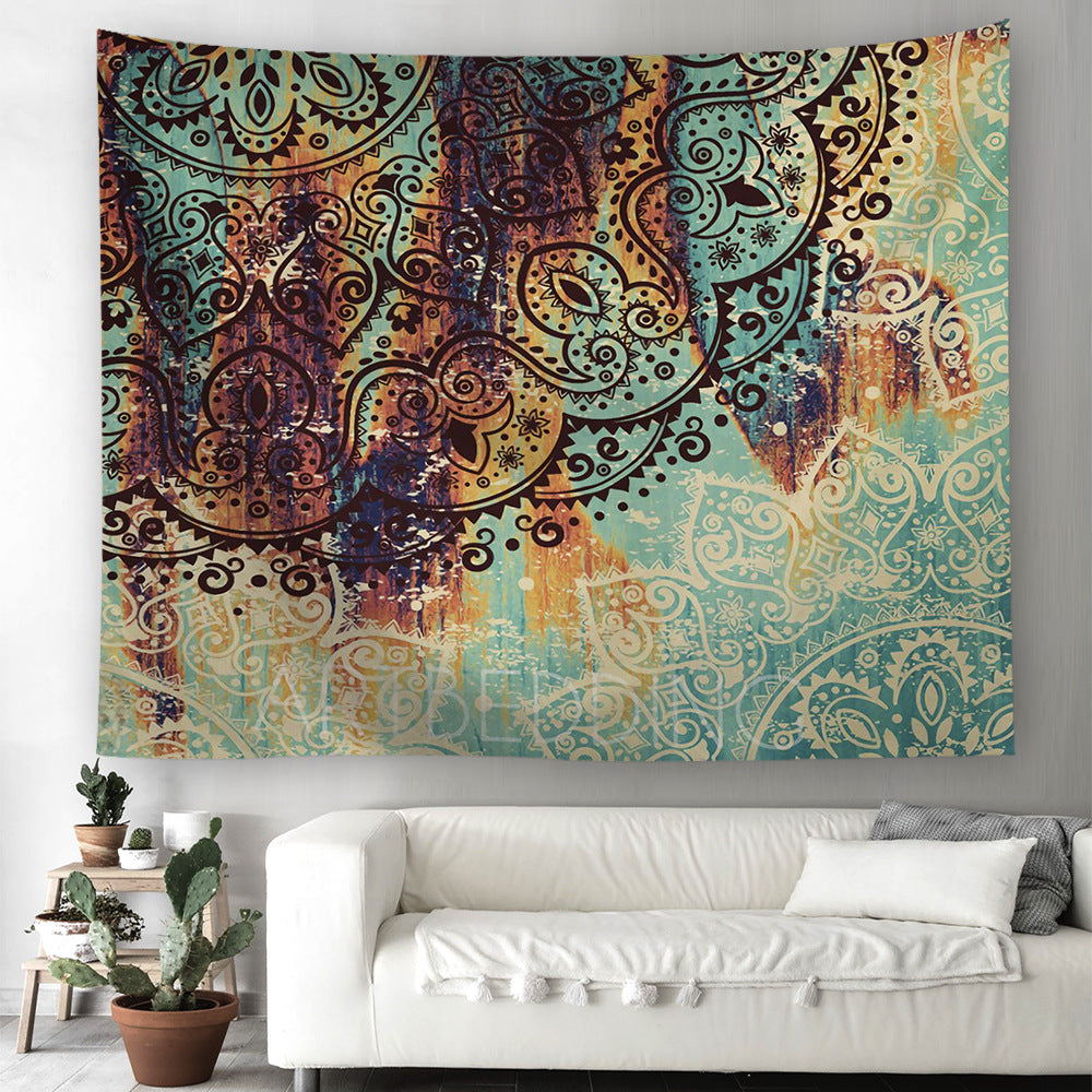 Colorful tapestry with intricate patterns hanging above a white sofa in a living room.