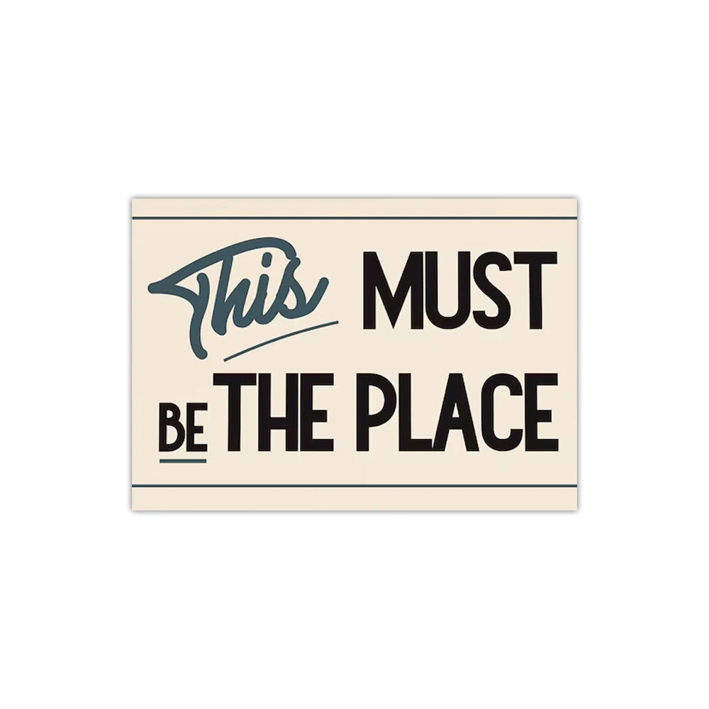 Motivational poster with text 'This Must Be The Place' on a beige background
