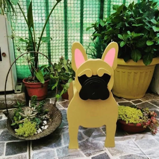 Yellow dog-shaped decorative item on a stone surface with plants in the background