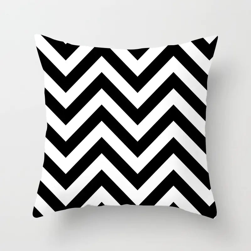 Pillow with black and white chevron pattern on a light gray background