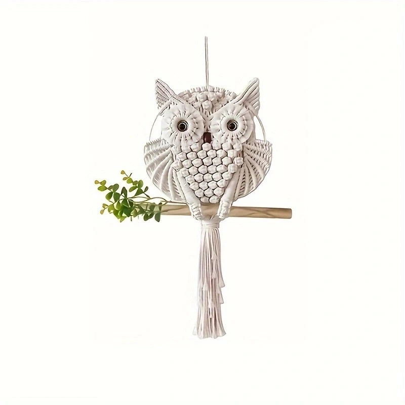 Macrame owl decor hanging on a branch with a white background
