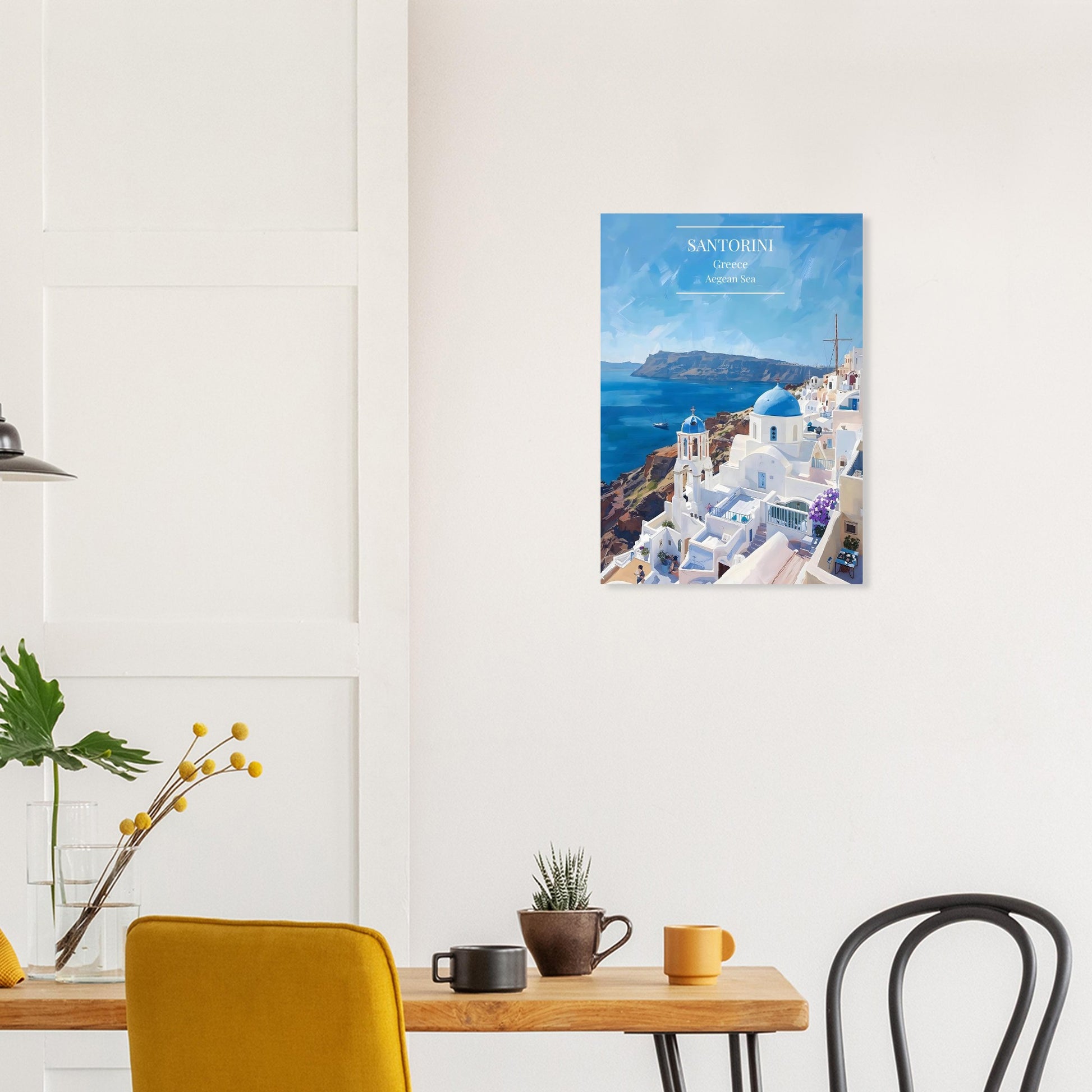 Santorini Greece Travel Poster on a wall above a wooden table.