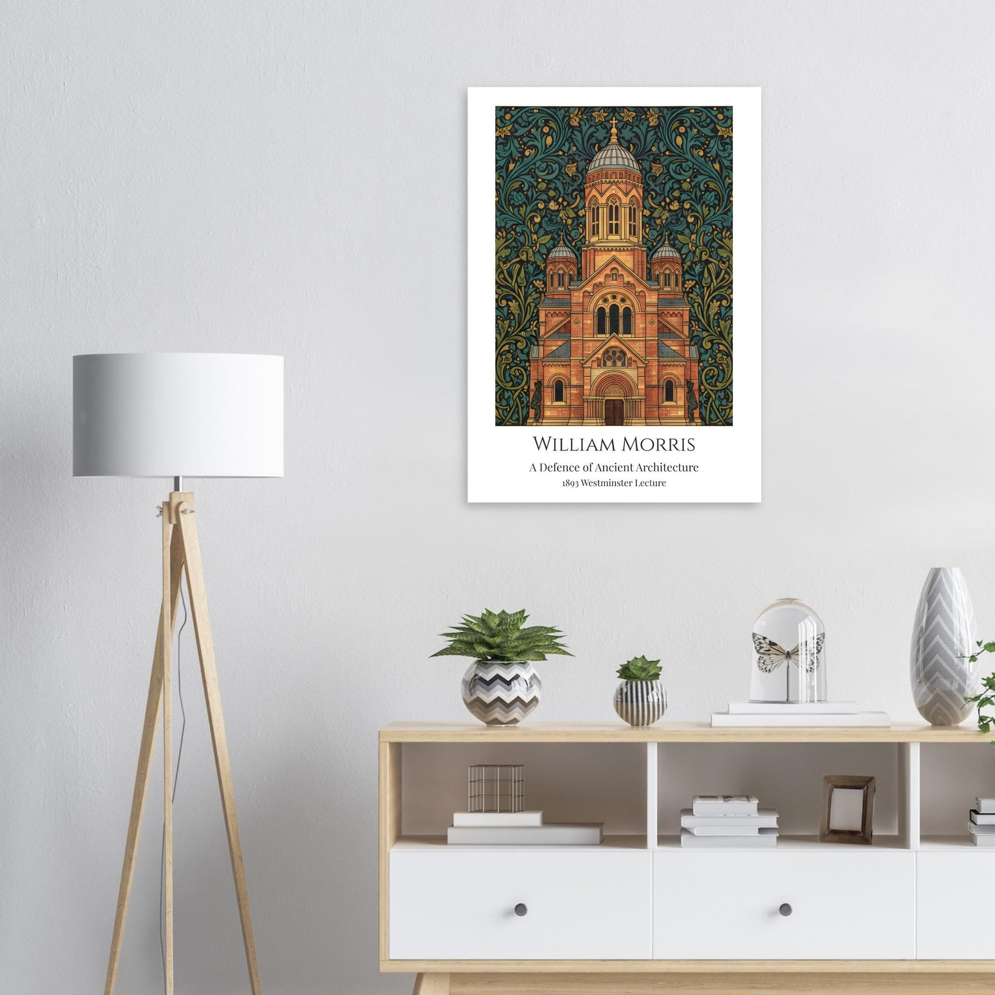 William Morris Framed artwork of Westminster Abbey with decorative elements on a wall above a white cabinet with decor items.