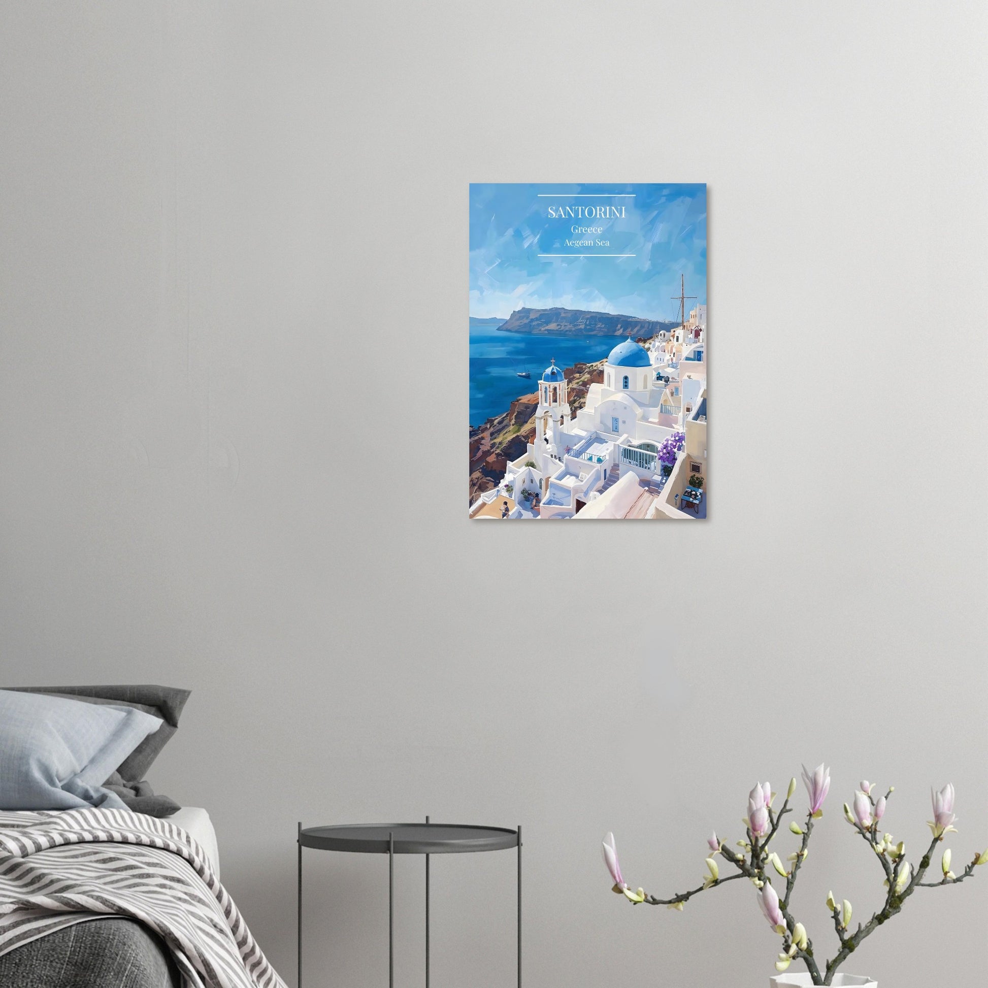 Santorini Greece Travel Poster on a wall above a bed with a side table and plant.