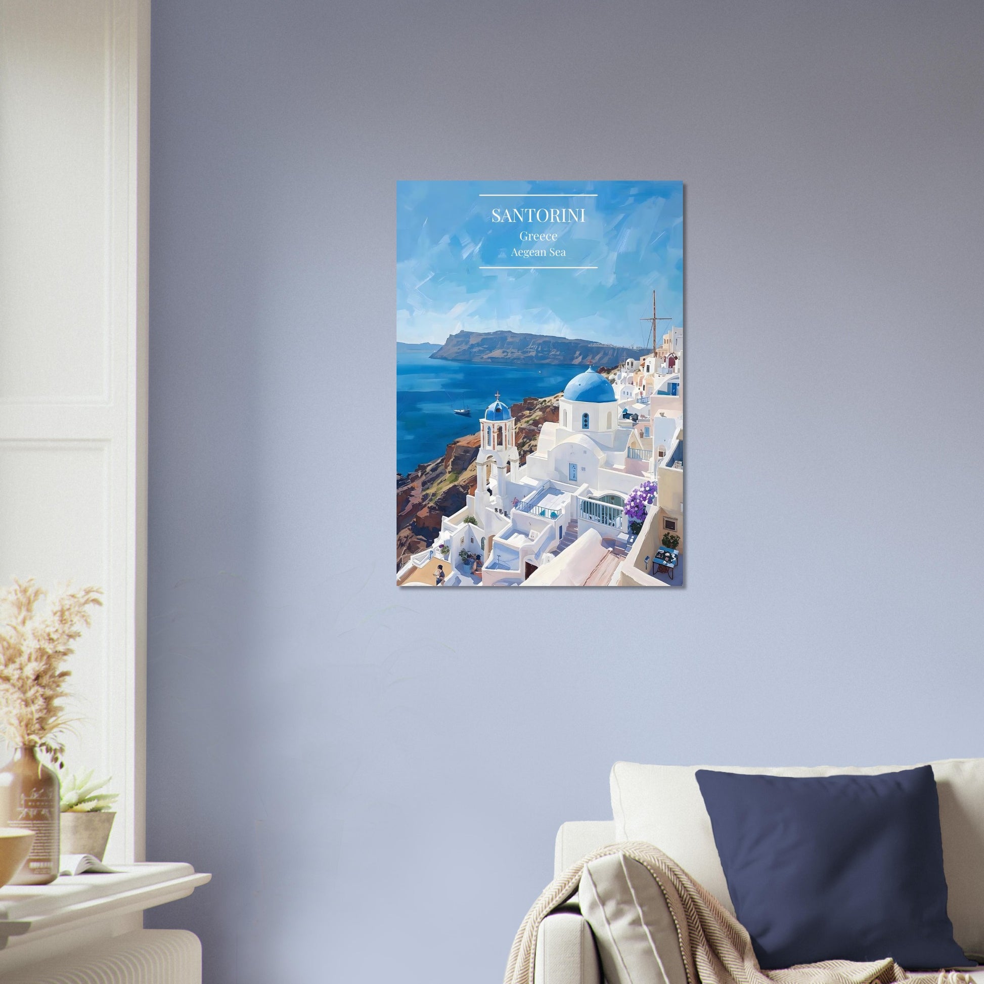Framed artwork of Santorini with blue sky and white buildings on a gray wall.