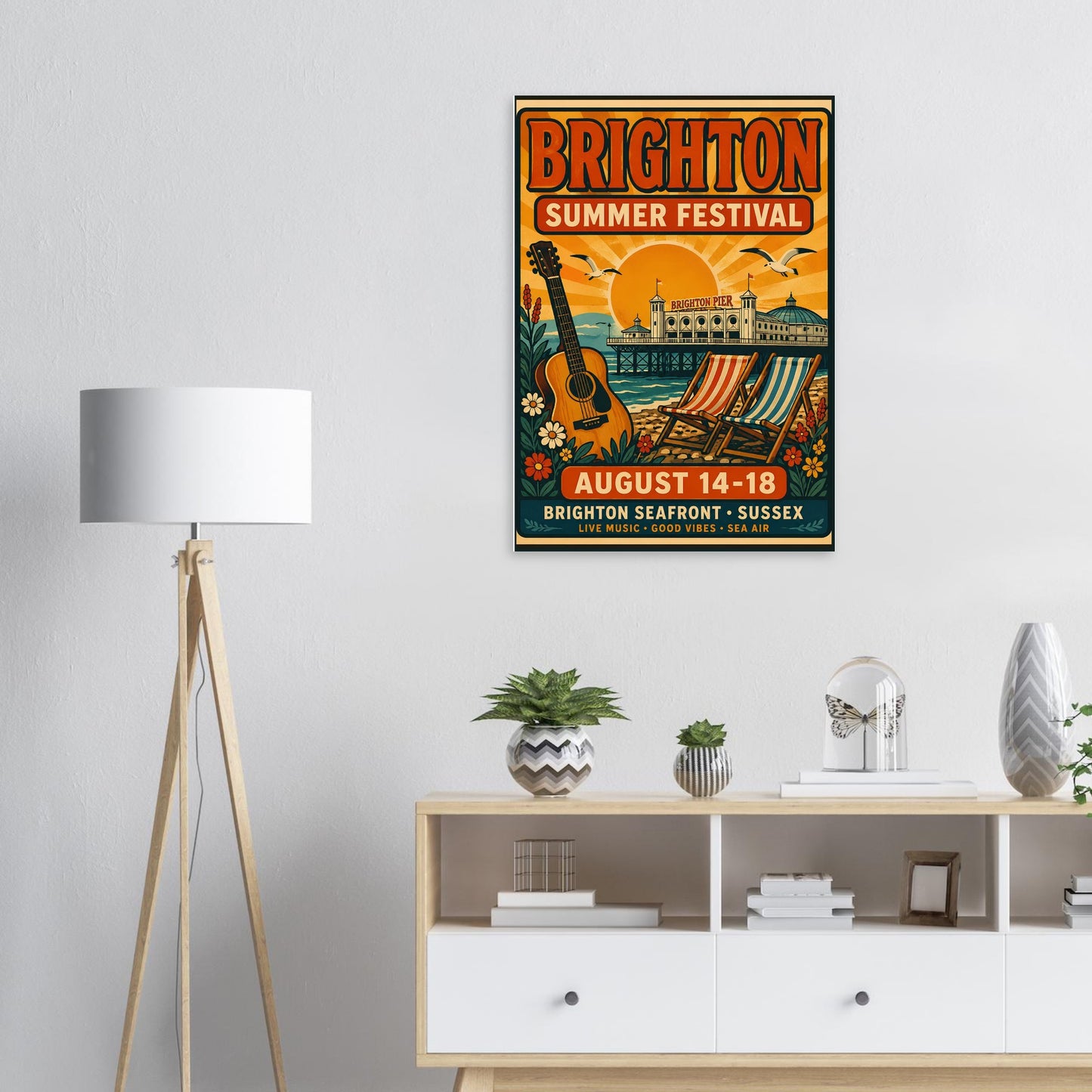 Brighton Summer Festival poster on a wall above a wooden cabinet with decor items.