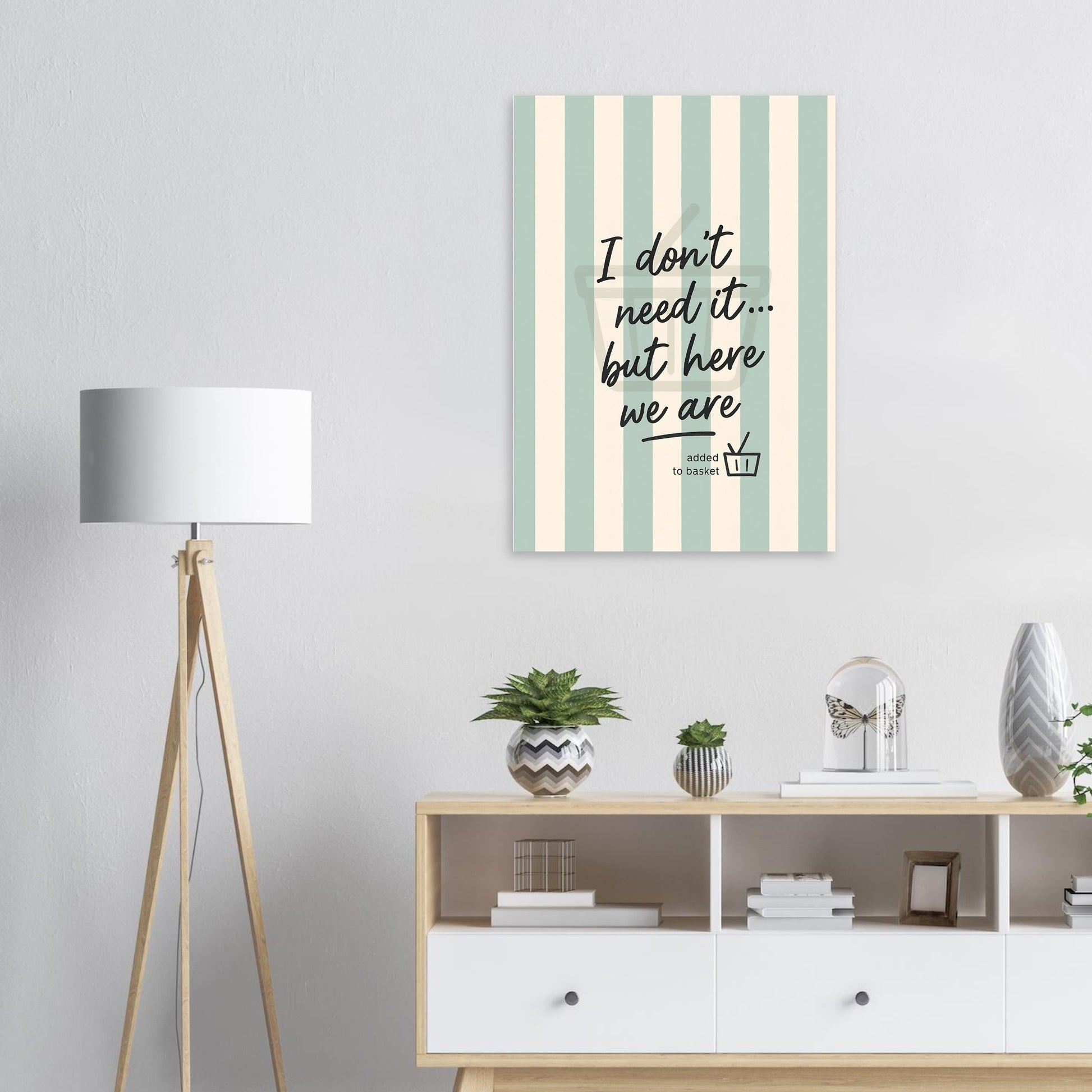 Decorative wall art with striped pattern and text in a room with a lamp and shelves.