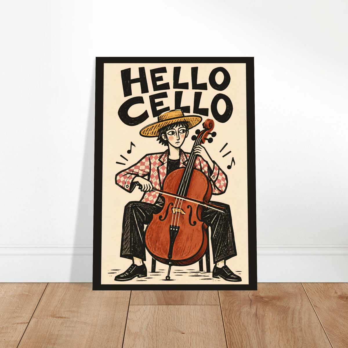 A framed art print featuring a retro-style illustration of a person playing a cello, with the text 'HELLO CELLO' at the top, leaning against a white wall on a light wood floor.