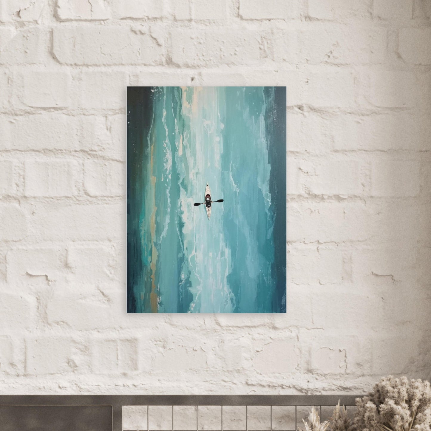 Canvas print of a kayaker in the water hanging on a white brick wall.