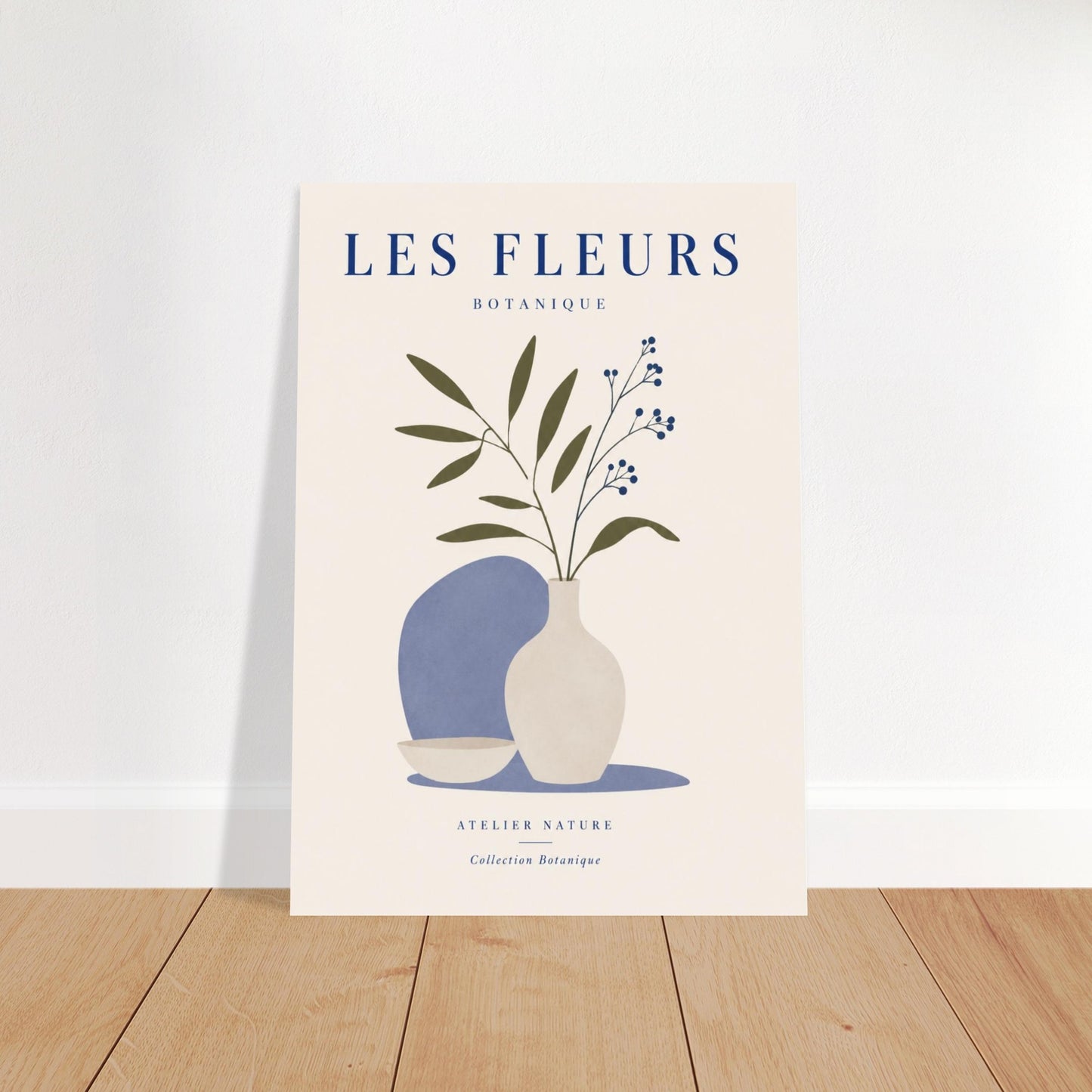 Blue floral botanical poster leaning against wall on wooden floor with minimalist styling