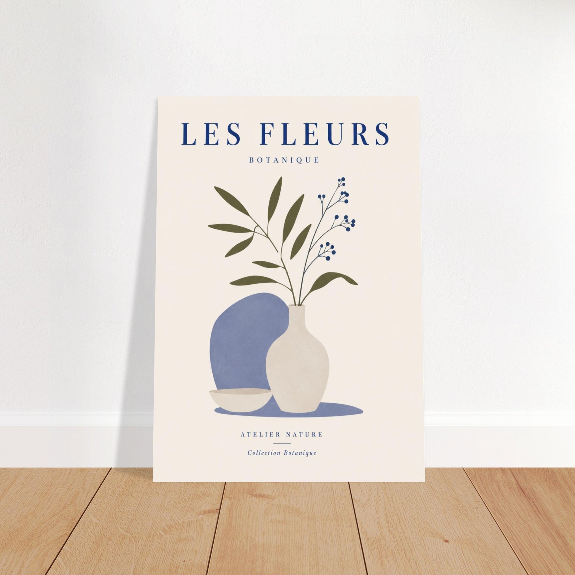 Blue floral botanical poster leaning against wall on wooden floor with minimalist styling