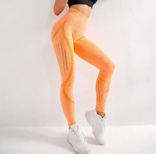 Orange leggings with mesh panels worn by a person on a white background