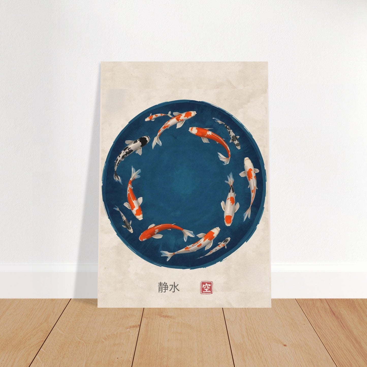 Poster with a circular design of koi fish on a blue background, placed on a wooden floor.