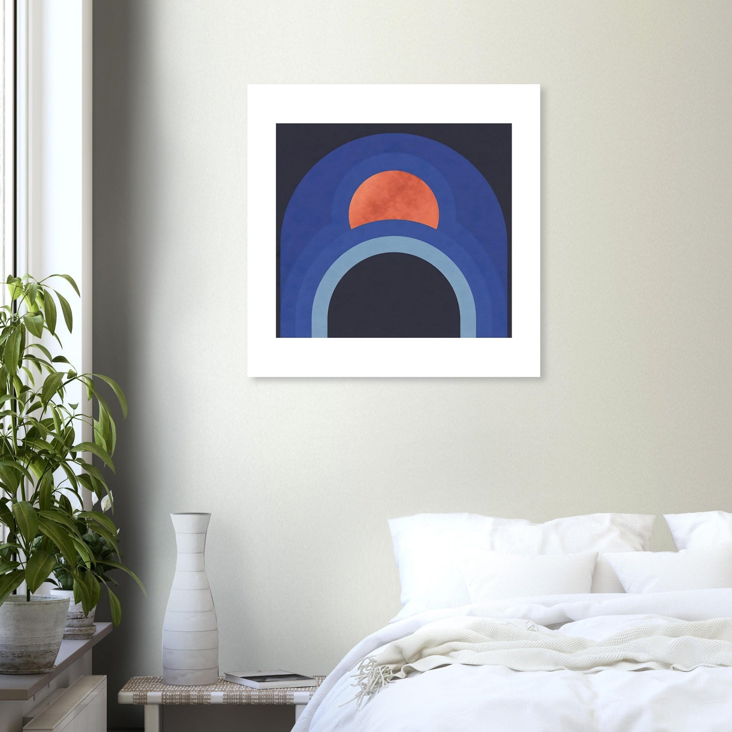 Contemporary blue arch wall print with terracotta sun in white frame in a bedroom setting