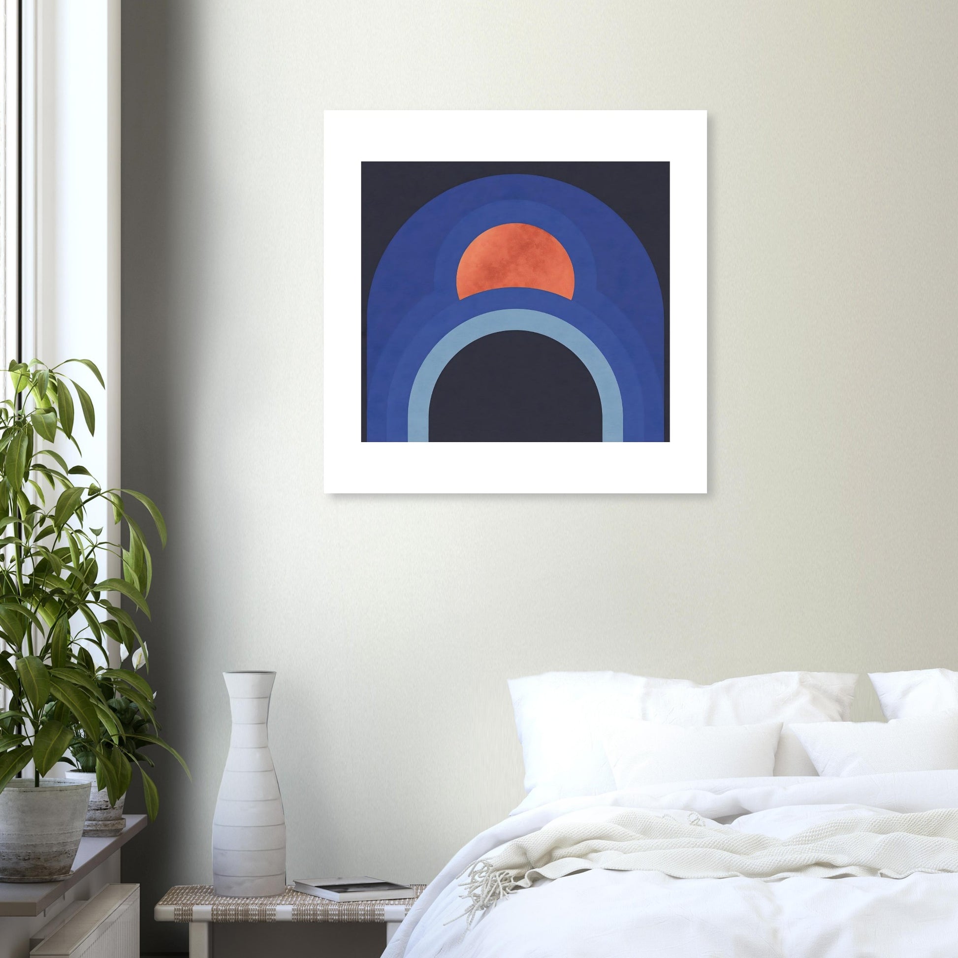 Contemporary blue arch wall print with terracotta sun in white frame in a bedroom setting