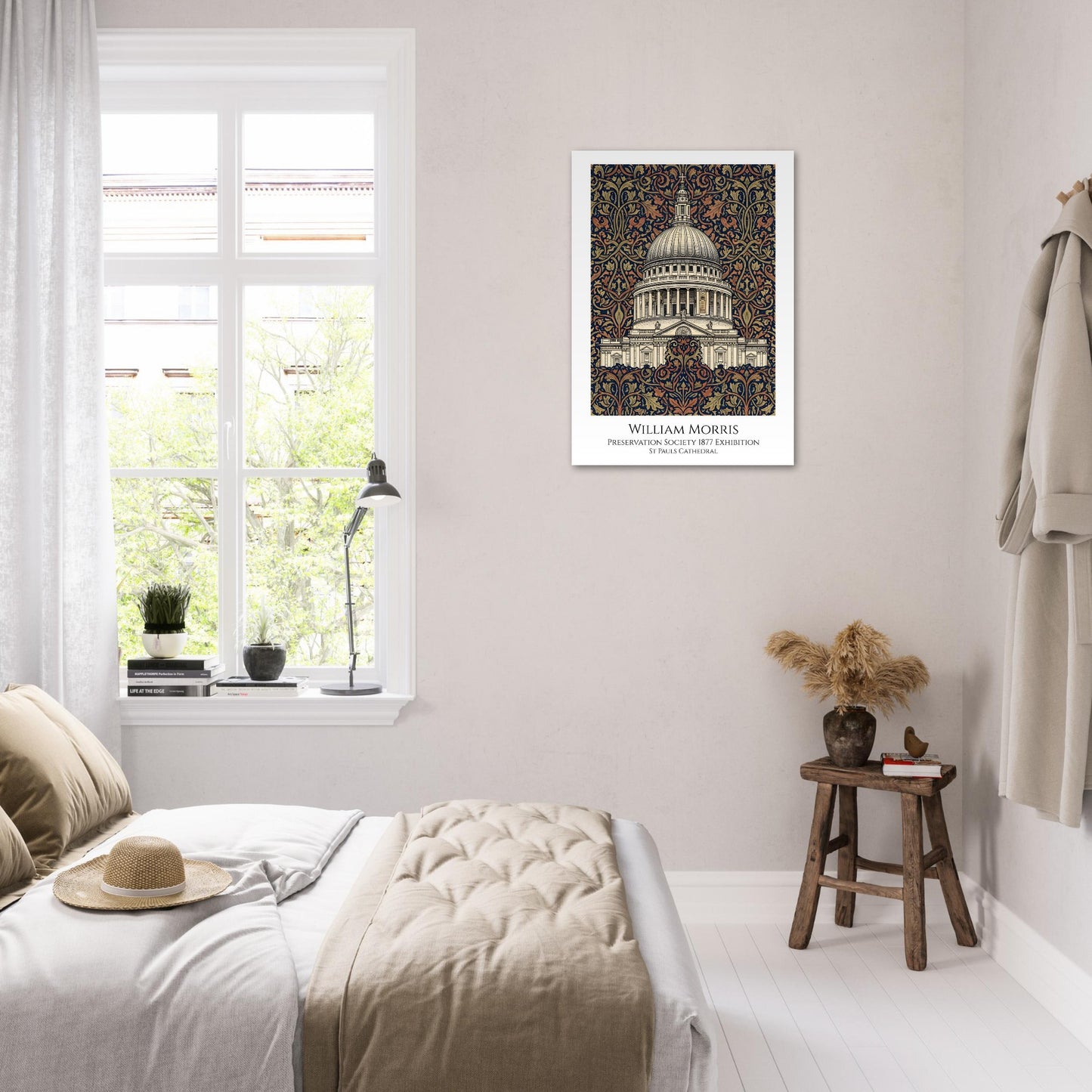 Framed artwork of a building on a wall in a bedroom with a window and stool.
