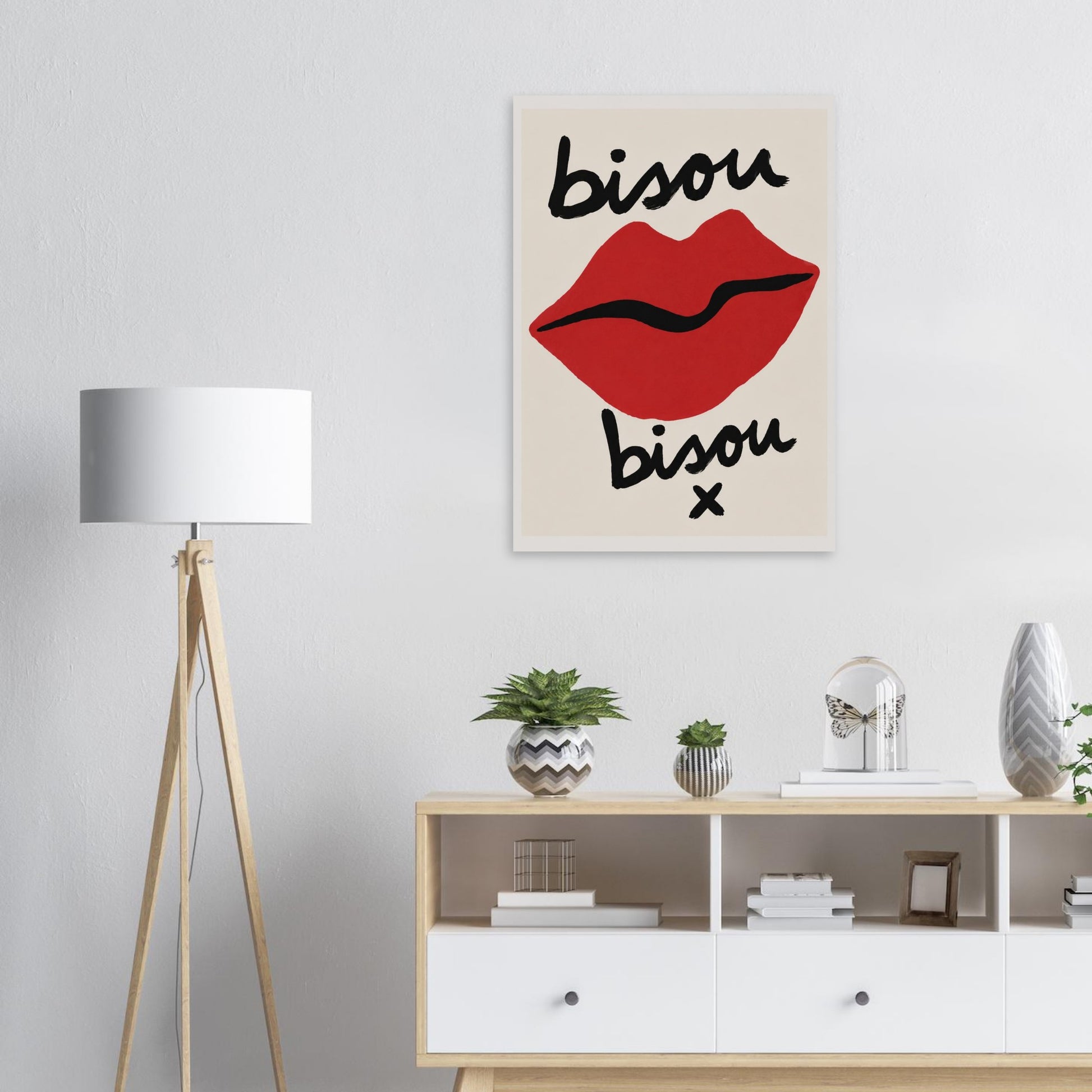 Decorative wall art with red lips and 'bisou' text in a modern interior setting.