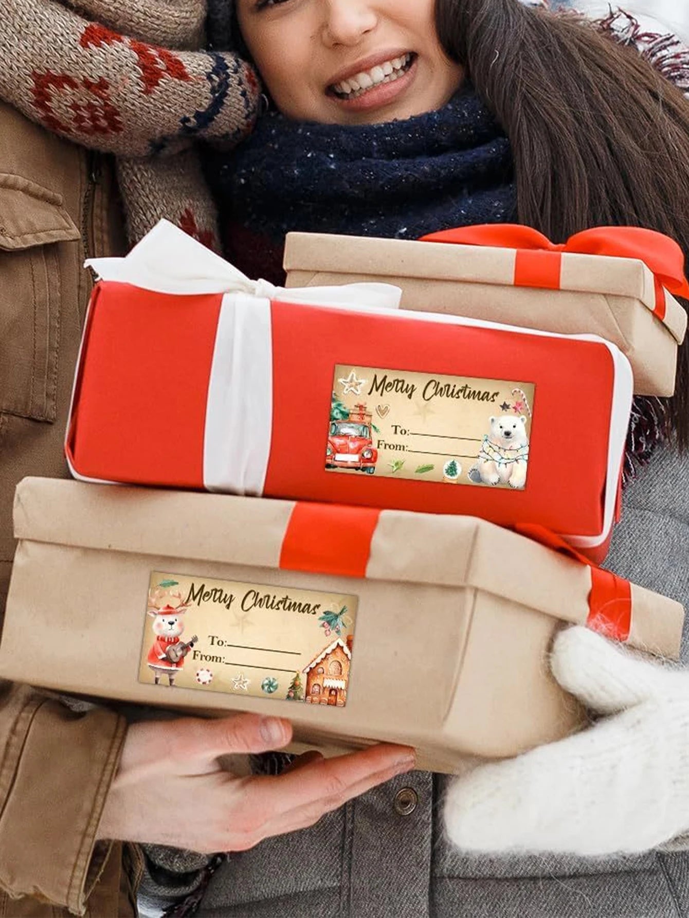 Person holding two wrapped Christmas presents with festive labels.