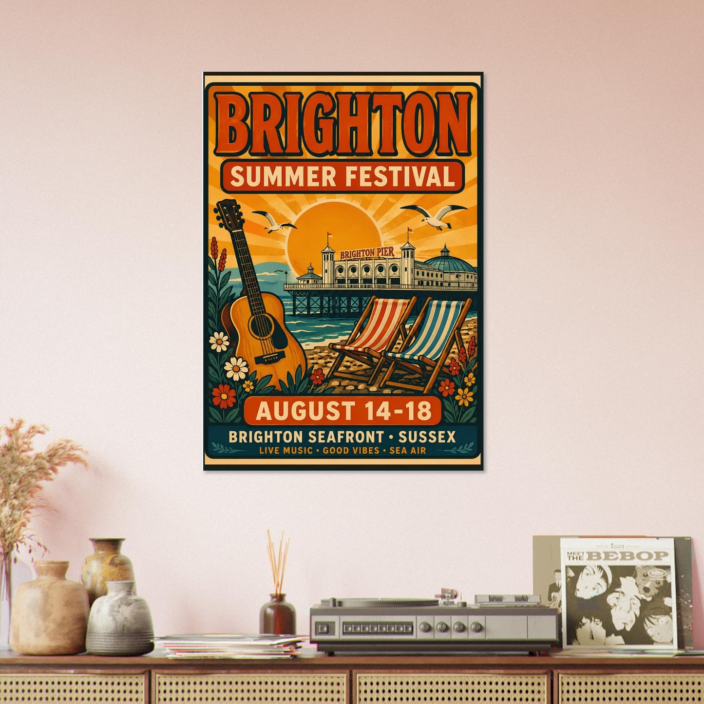 Poster for Brighton Summer Festival on a wall above a wooden shelf with decorative items.