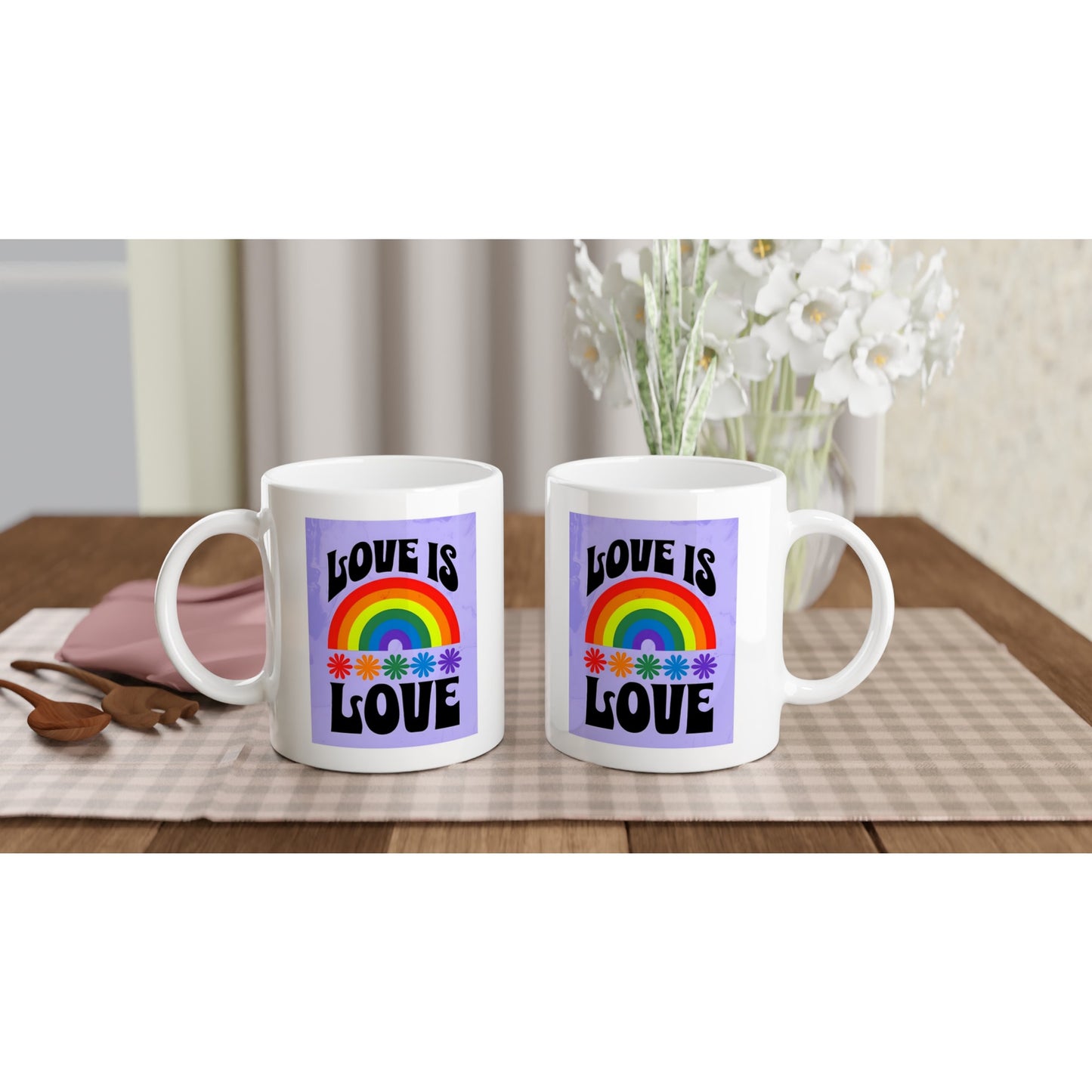 White mug with a rainbow and 'Love is Love' text on a purple background