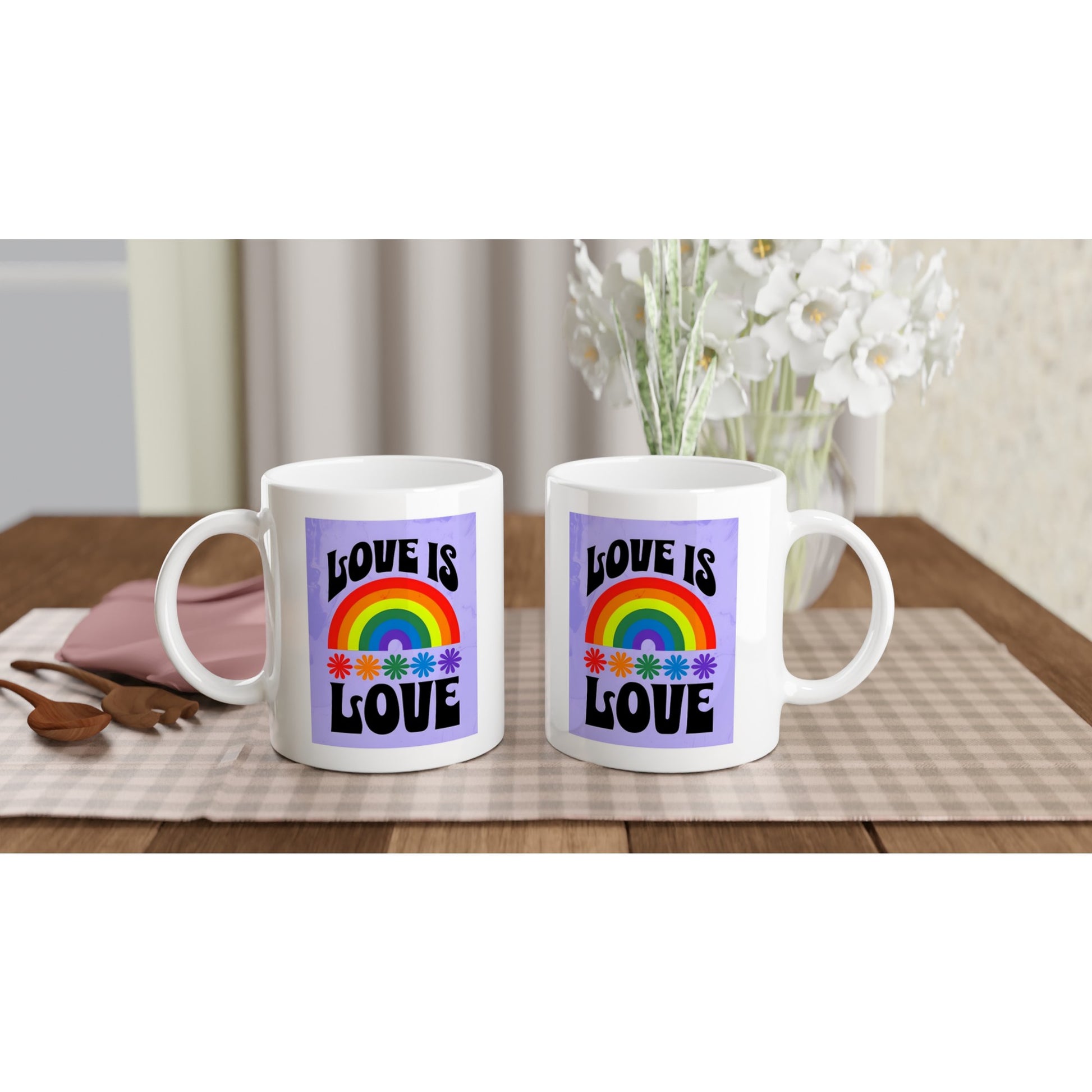 White mug with a rainbow and 'Love is Love' text on a purple background