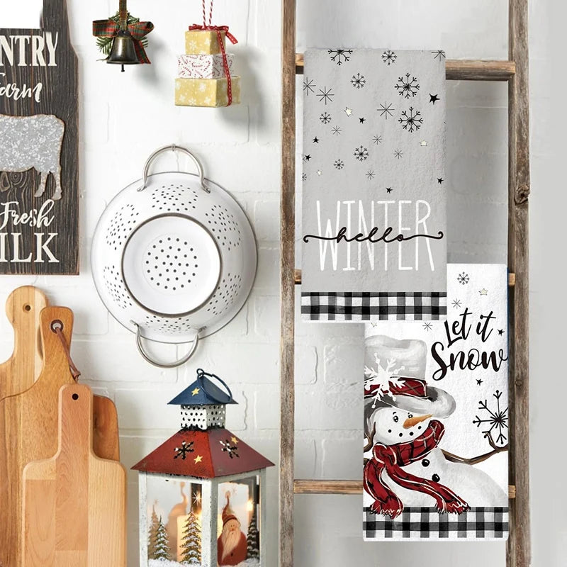 Decorative kitchen wall with a wooden ladder, Christmas-themed towels, and festive decor items.