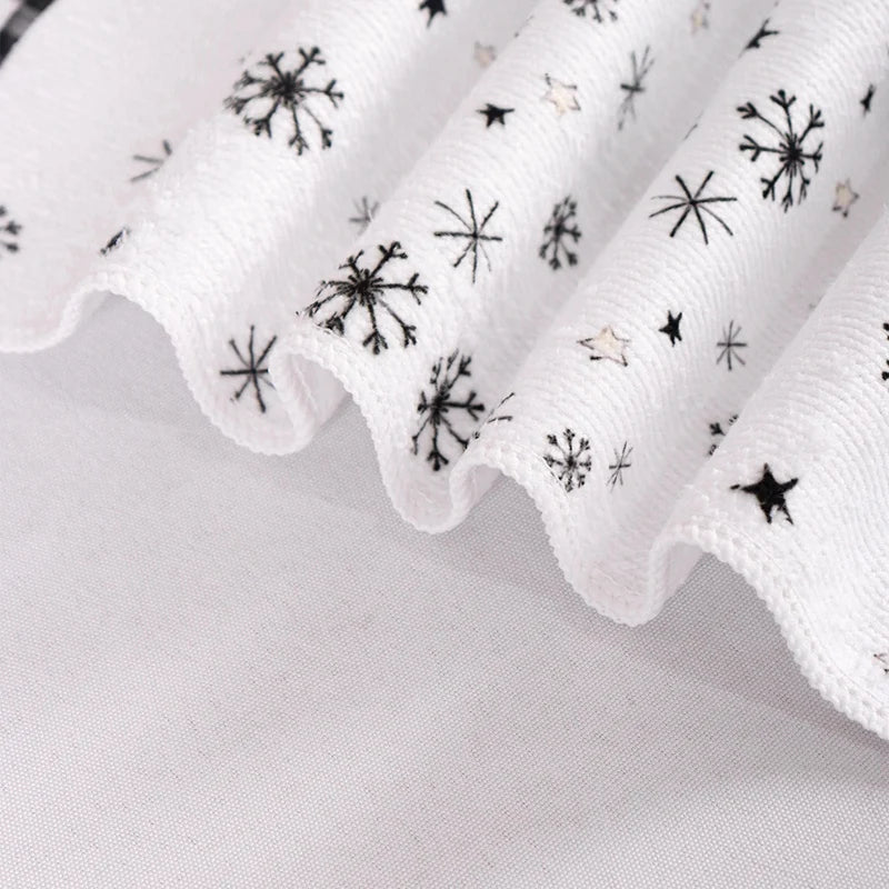 White fabric with black star patterns on a light gray background