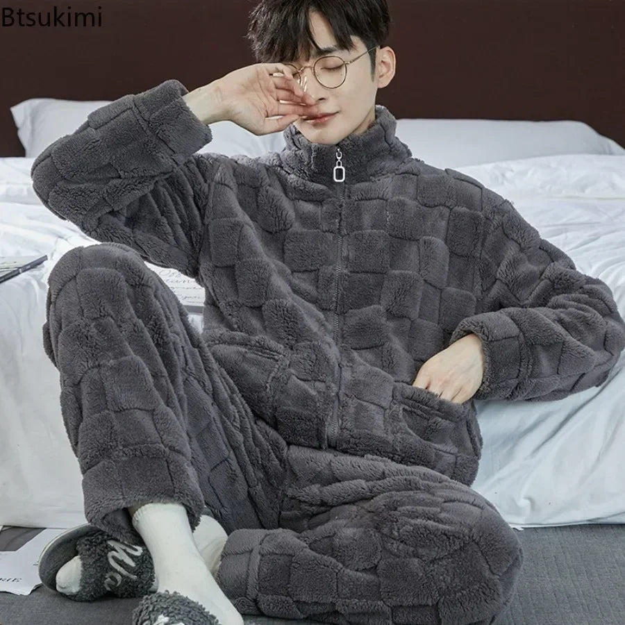 Person wearing a gray quilted onesie sitting on a bed.